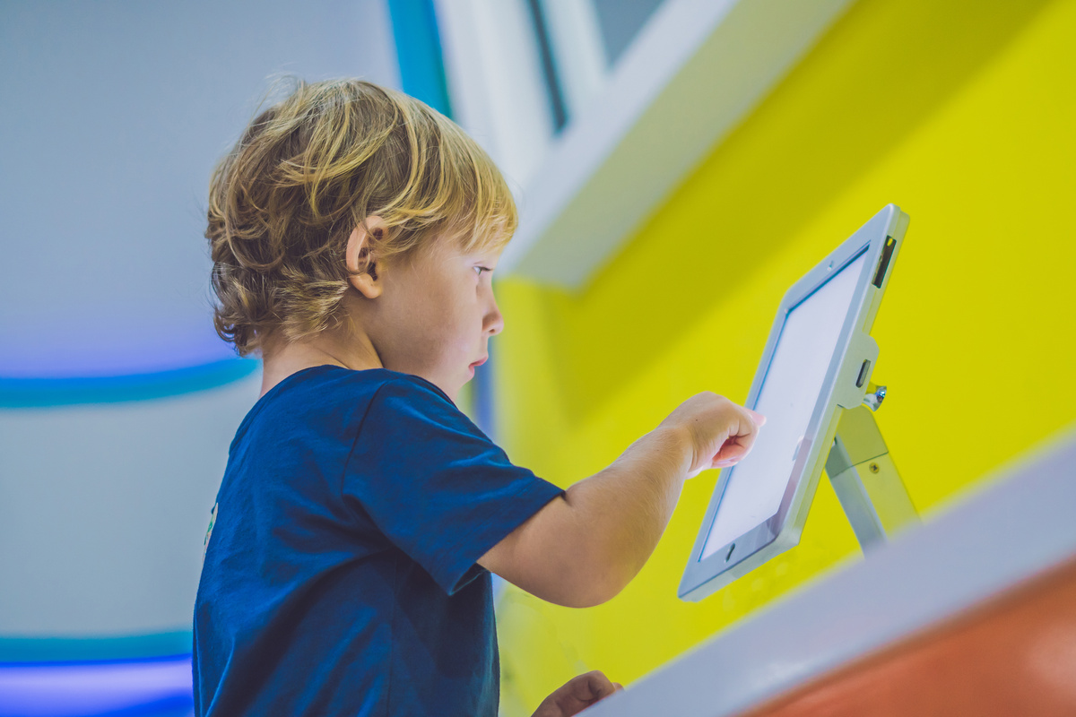Boy Playing with Digital Tablet. Children and Technology Concept